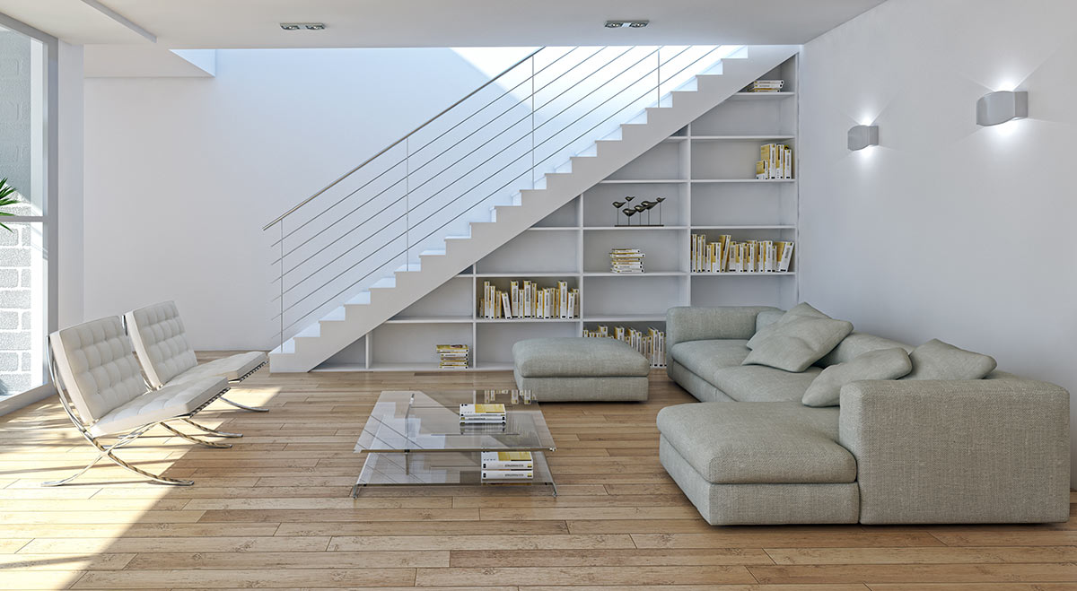 Séjour moderne avec bibliothèques sous escalier, parquet et canapé d'angle gris.