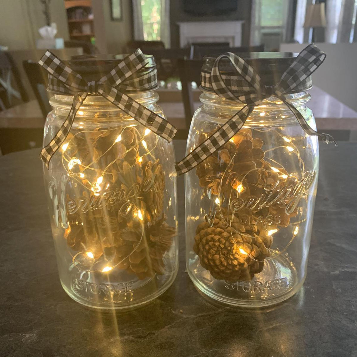 Lanterne fait maison avec bocaux en verre, pomme de pin e guirlande lumineuse.